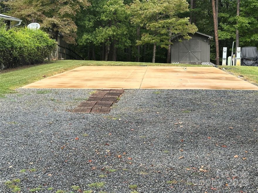 Rare Vacant Lot in the lake front gated community of Badin Shores Resort. This flat lot has gravel driveway with large concrete pad so bring your Camper and you're ready to go. Another option could be a park model home or even a modular home. (See Building guidelines for acceptable possibilities) Lot also includes an "A Lot" that gives you extra space for a  sitting area, or parking area. The storage building provides the perfect spot for all your floats, beach chairs and lake toys.  The Resort offers many amenities that include 24-hour entrance gated security at the entrance, swimming pool, sandy beach and swim area, fishing pier, putt putt, basketball/pickleball courts, sand volleyball courts, picnic areas, playgrounds, waterfront boardwalk, community boat ramp, clubhouse and  more.