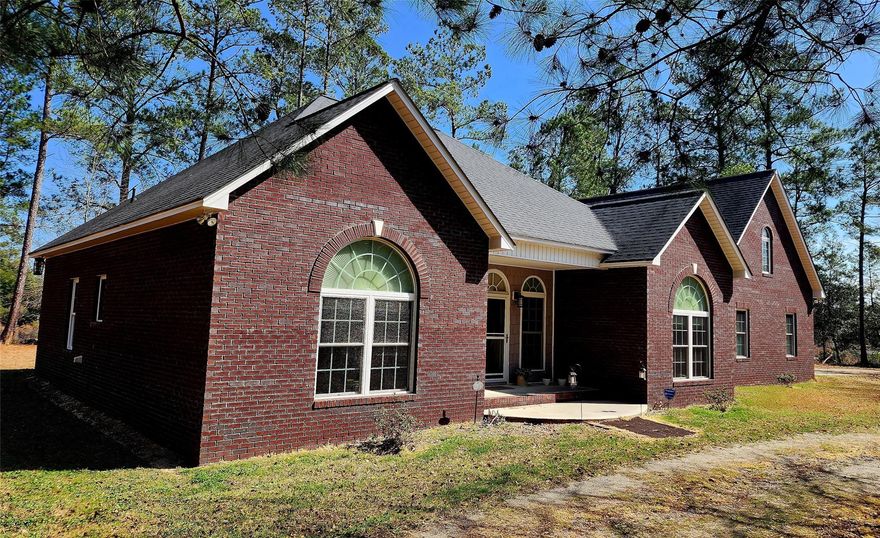 Find peace and tranquility in this beautiful custom-built brick home on 67 acres with 3 ponds. You will enjoy the amazing views day and night. This 4 bedroom 3.5 bath home with office was built with close attention to details. 2 pantry kitchen with quartz countertops, soft close hinges, and pull-out bottom cabinet drawers. Office has a beautiful view of the pond and heated floors. Large master bedroom with jacuzzi in the bathroom plus walk thru closet. Enjoy the screen porch overlooking the pond or have a fire in your outdoor fireplace under the stars. This home has county water, garbage collection, fiber internet and television, a water filtration system in the kitchen, a whole house generator, and a transferable security system. The 500lb Propane tank is used for the stove, fireplace, gas grill, and generator. Barn has electricity, water, and approx 3 acres professionally fenced.
