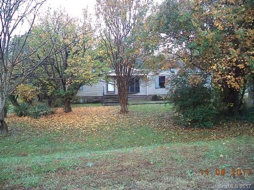 Double wide manufactured fixer upper. Home in overall poor condition and is sold in as is condition. Value is in the land, septic system & well. Property has nice gazebo & storage shed. Convenient location.  No power. Water is not on. Please show during daylight hours only. Buyer to verify all information.
