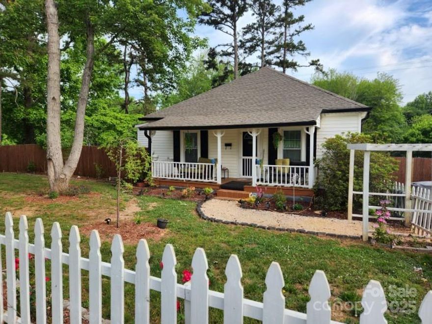 WANT THAT SMALL TOWN FEEL? This cute as can be 2 Bedroom, 2 Full Bath home on a fully fenced corner lot is for you!   Privacy fence in back and picket fence in front.  This house has a newer roof, HVAC, windows and LVP flooring throughout. New insulation was put in the attic and underneath the house approximately 2 years ago.   Close to downtown for dining and entertainment.  Please note:  Age of Home is approximate. Property is being sold as-is with no known issues.