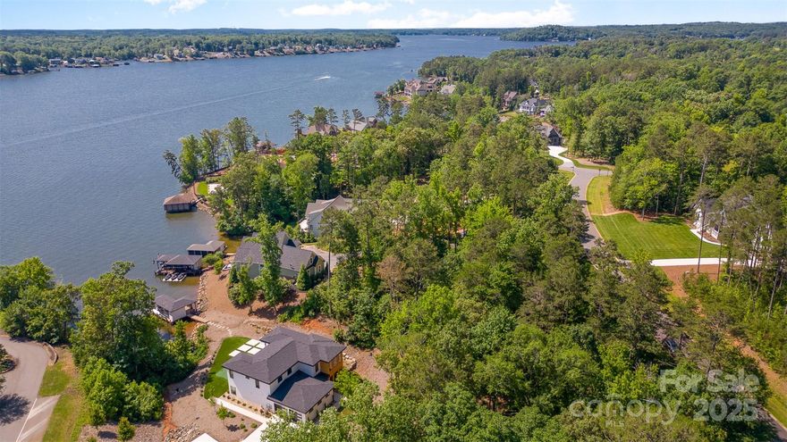 Back on the market, no fault of the seller. Modern, simple, luxurious lake living at its best on over a ~1.15 acre lot. Custom built for owner that appreciates and desires seamless indoor/outdoor living and chef level appliances. Tile and landscaping packages on this home will not disappoint and are a must see. Low maintenance artificial turf / putting green in the backyard, along with outdoor fireplace and seating area for outdoor enjoyment. Long range views, dual master suites, all bedrooms have their own private baths, with large windows to take in the views of the lake. Enjoy the patio screened in, or open with the retractable screen, and pocketing glass door system. Additional adjoining lot (45R) is 1.554 acres and is owned by sellers LLC, can be purchased to create estate sized lot (combined size is ~2.62 acres), should buyer want to add guest home, or provide additional privacy and shoreline, creating a private cove feel with the 2 combined lots. Listing agent is owner.