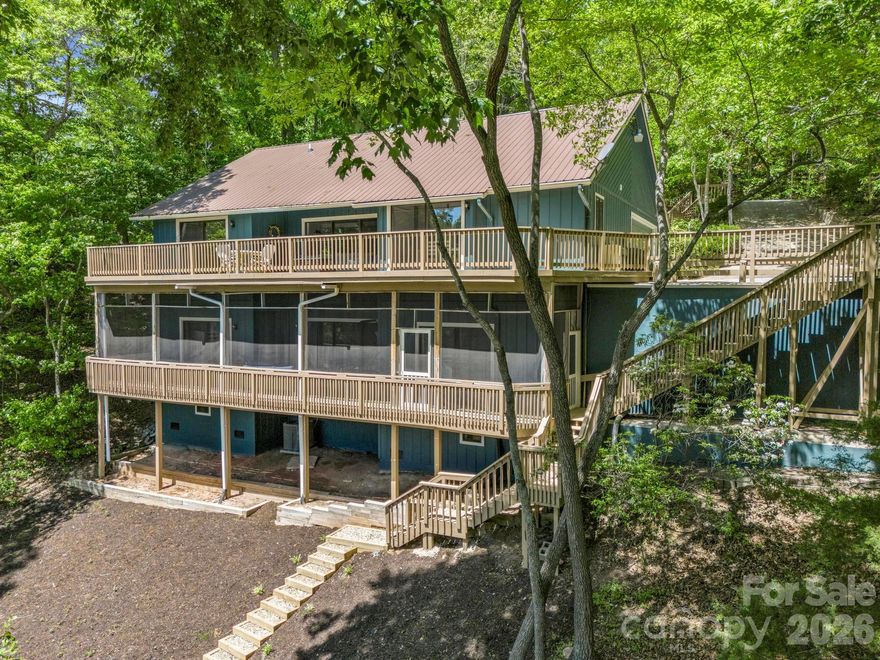 Nicely updated home, overlooking the 11th green of the Bald Mountain Golf Course, located behind the security gates and within a short walk or golf cart ride to all of Rumbling Bald on Lake Lure’s amenities. This 3 bedroom + bonus room, 3.5 bath home boasts an updated kitchen with SS appliances, granite countertops, a two-story great room with floor-to-ceiling stone gas-log fireplace and wood beamed ceiling, and primary BR on the main level, plus a large family room and 3 add’l guest rooms downstairs. Expansive decks run along the rear, main, and lower levels overlooking the golf course and winter lake views. The lower-level deck is fully screened in. Rumbling Bald amenities include 24-hour security, lake access, private beach, indoor/outdoor pools, tennis, two 18-hole championship golf courses, fitness center, spa, restaurants, bars & more! This home would make a great full-time residence or a vacation rental property. Available turnkey with the right offer - come start living the resort life!
