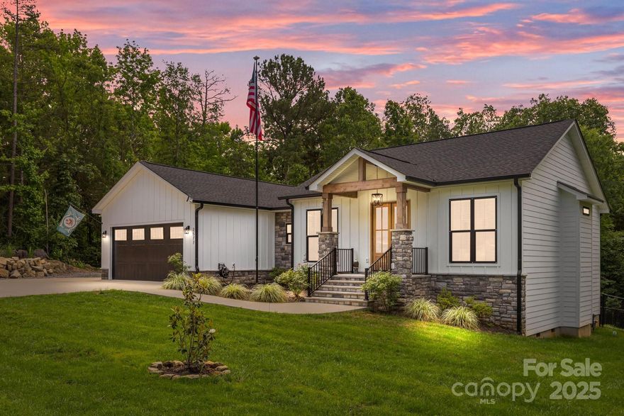 Custom-built ranch on a private 1.2 acre lot where craftsmanship meets modern elegance. From the moment you arrive, you'll be captivated by the sleek black windows/gutters, accented with stonework/wood beams that frame the front porch & double door entry. Step inside to an open-concept layout designed for entertaining & everyday living. The heart of the home is the chef’s kitchen, featuring ceiling-height cabinetry, quartz counters, farmhouse sink, & Cosmo gas range. Butler’s pantry with a beverage fridge & prep area for those who love to host. Split bedroom layout with primary suite tucked away. Indulge in a spa-worthy bathroom retreat. Off the main living area, step through 8-ft double doors into a breathtaking 3-season room with EZE Breeze windows, floor-to-ceiling stone fireplace, wall heater & oversized ceiling fan for year-round enjoyment. The expansive patio offers even more room to relax & entertain, complete with built-in grilling station & hot tub. Large laundry & drop zone.