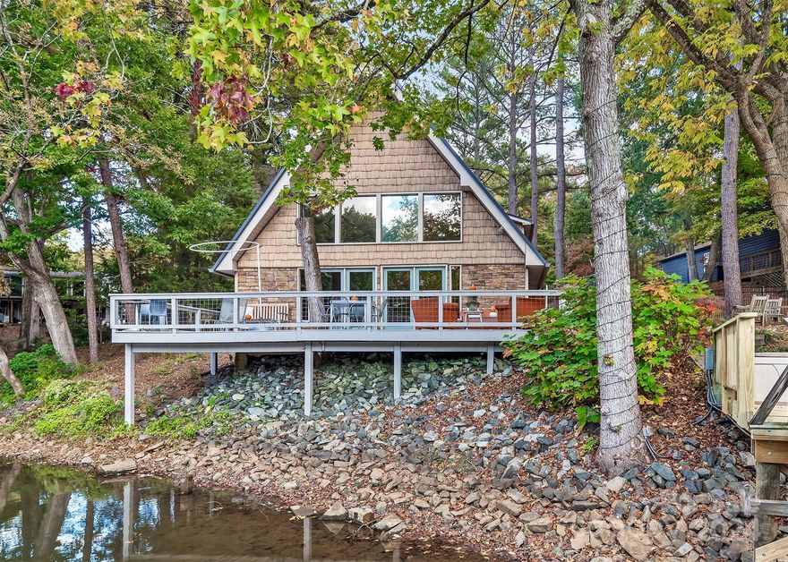Beautiful private waterfront home on Lake Wylie.  Situated on over 1.2 wooded acres, this home boasts Lake Living and Water Fun.  Private dock and boat lift are steps away. Large deck perfect to watch the sunset or enjoy morning coffee. Great for a get away retreat or full time living. All new Heat and Air Systems installed in 2024 as well as Secure Private remote gate.  Great room features open floor plan with new gas logs, vaulted ceiling and expansive views of big sky and cove waters.  Kitchen has breakfast bar that seats 4 and adjacent dining area.  Remote shades in the Great Room.  Primary Bedroom off Great Room features Walk- in closet and new touches to primary bath. Upper floor find 2 bedrooms, full bath and open loft with lake views. Detached garage has workshop and large unfinished loft that could be finished for office or extra living space.  Trimlight Lighting customizable on your app.  Entrance to the house is on the upper level from the garage.
