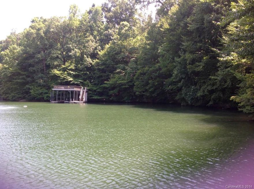 Hard to find WATERFRONT ACREAGE in Mooresville!  Approx. 611’ of water frontage.  Two level dock/boat slip already in place.  Top deck (sun deck) constructed of very strong and dense Brazilian Palupe hardwood.  Lot is densely covered with mature hardwoods.  Beautiful topography.  Perfect for a very private waterfront estate or for future development.