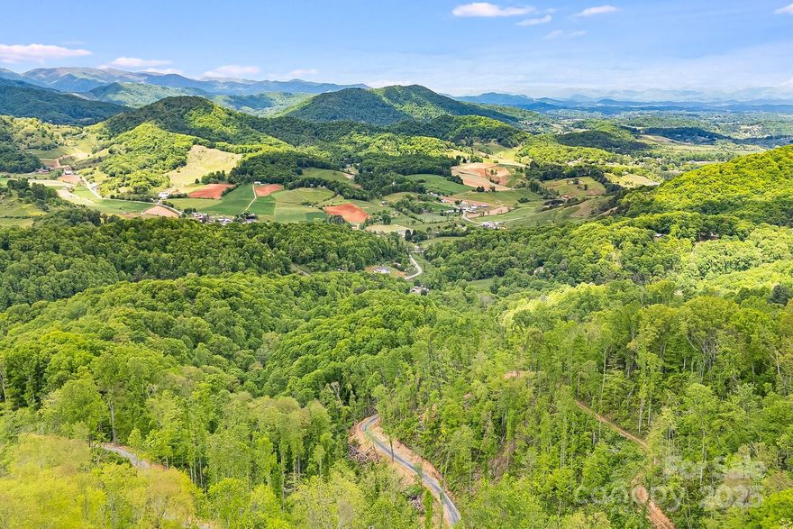 Incredible opportunity in Leicester - over 65 acres of privacy and property that extends to the top of the mountain! Breathtaking long range, layered mountain views from multiple sites on the property. Timber on property was recently select cut, with lots of trees left standing. A new partially concreted driveway connecting to state rd., with new grading and gravel on remaining drive leading to homesite. Homesite is near lower end of tract and cleared/level, ready to for your builder. Newly built graveled road that leads to top of property - easy to access with a vehicle. Lots of wildlife present - potential for private mountain getaway, recreational property, camping, investments & more. Potential for additional viewshed that could be opened up significantly. Bring your vision and ideas and make sure you see this special property & all the potential it offers. Shown by appt only. See video here: https://listings.wncrealestatephotography.com/videos/0196c0eb-713d-7065-8b95-83a0e2373590