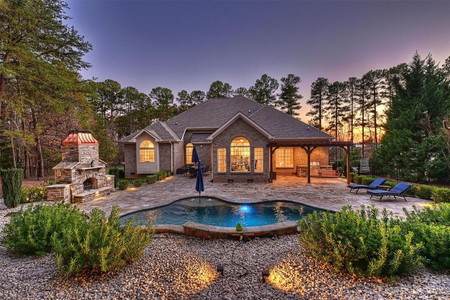 Exceptional Opportunity for a Turn-Key One Story Home w Lake Norman Water View! 4 Bedrooms/3 Full Baths & Nearly 3,000 HLA with Astonishing Outdoor Living Area that Includes In-ground Salt Water Pool, Stone Fireplace w Hand-Made Copper Hood, Outdoor Kitchen & Dining Area! 1.21 Acre lot Provides a Blank Canvas for any Home Buyer to Expand this Oasis as they see fit and Guarantees the Much Deserved Privacy. 3 Car Side Load Garage, Full Brick Exterior, Thoughtful Split Wing Floor Plan & Heavily Milled Moldings are just a Few Features. Updated Kitchen includes Cabinetry, Backsplash, Marble Counter Tops & SS Appliances. Expansive Owners Suite w Updated Bathroom is a Perk! Shimmering Hardwoods, Modern Tile Flooring & Tons of Natural Light! High Ceilings Create a Spacious Feel while the Sunroom/Breakfast Area offers Full Window View of Pool & Mature Trees! Working From Home has never been Better as the Oversized Office boasts a Gorgeous Water View of Lake Norman. It's time to enjoy Lake Life!