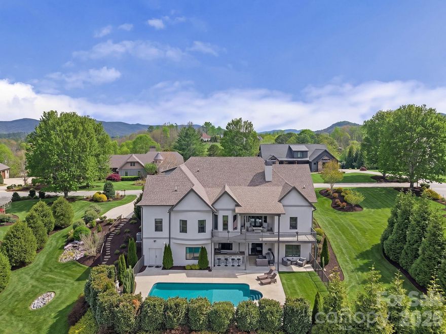 A masterclass in modern Green Built luxury and high-performance design, this custom home at 64 Water Hill Way offers an elevated living experience where architectural beauty, sustainability, and resort-style outdoor living converge. Built by award-winning Red Tree Builders and set within the gated Waterford Lakes community, the surroundings offer winding trails, peaceful ponds, and a private equestrian facility that adjoins the community, creating a setting that feels worlds away, yet perfectly connected. 

Constructed with insulated concrete forms, the home delivers superior energy efficiency, structural integrity, and a remarkably quiet interior. A curated suite of wellness-focused features, including whole-home water filtration, reverse osmosis drinking water, UV and HEPA air purification, whole-home ERV system, and low-VOC materials, enhances both comfort and long-term health.

Inside, 10-foot ceilings and natural hardwood floors create a sense of openness and continuity, while the main living space is anchored by a chef’s kitchen featuring custom cabinetry, quartz surfaces, a marble backsplash, and a premium Viking appliance suite with a gas range and pot filler. Thoughtfully selected lighting from Christie’s, a whole-home audio system, and a natural gas fireplace elevate the experience.

The main-level primary suite offers a calm and private retreat, complemented by a spa-inspired bath designed for relaxation and restoration. Two additional bedrooms provide comfort for guests, while the upper level introduces a flexible bonus suite and walk-in attic for abundant storage and future expansion. The walk-out lower level is arranged as a fully independent living quarters with a private entrance, kitchen, bedroom, full bath, and laundry, offering versatility for extended stays or multigenerational living.

Outdoor living is nothing short of exceptional. A heated saltwater pool is framed by open views and manicured grounds, while a covered terrace and fully equipped outdoor kitchen featuring a Blaze 4-burner grill, cast iron sink, and in-ground gas hibachi create a setting designed for effortless entertaining and quiet moments alike. This is where the home truly comes to life, offering a private, resort-caliber experience that feels both elevated and entirely your own. 

This is mountain living reimagined through a lens of modern luxury and thoughtful design.