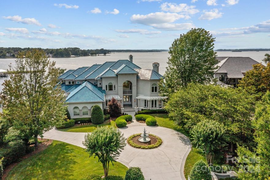 Presenting an extraordinary estate nestled along the premier waterfront of Lake Norman, offering unparalleled luxury and breathtaking vistas. This magnificent Mediterranean-style mansion, meticulously crafted by Christopher Phelps, encompasses nearly 11,000 square feet of opulent living space. Distinguished by its hard coat stucco exterior, complemented by sophisticated synthetic stucco trim, and crowned with a durable 50-year tile roof, this residence epitomizes elegance and endurance.  Two-level lakefront additional living quarters and an attached townhome perfect for extended family, in-laws, and guests are seamlessly connected yet separate from the main house. One unit features handicap-accessible bathroom facilities and a full kitchen with separate entrances that provide privacy and convenience.  See attachments for a full, detailed description of the property and more details on the six (6) heating and a/c units.