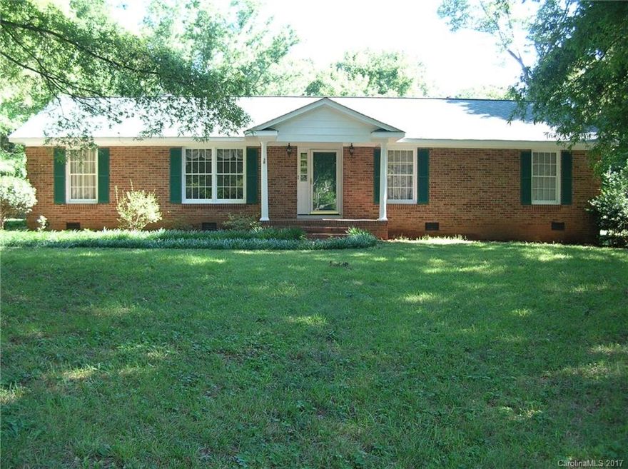 Lovely three bedroom, two bath brick ranch on over an acre of land in sought after Mint Hill.  Some of the many updates include: kitchen: stove, dishwasher, microwave and light fixtures; very handsome laminate flooring, interior paint; exterior trim and large shed painted, new gutters; well pump (see agent for details); roof aprox. 2010.   Spacious storage area in carport; amazing very large shed with electricity.  Stainless steel refrigerator to convey.