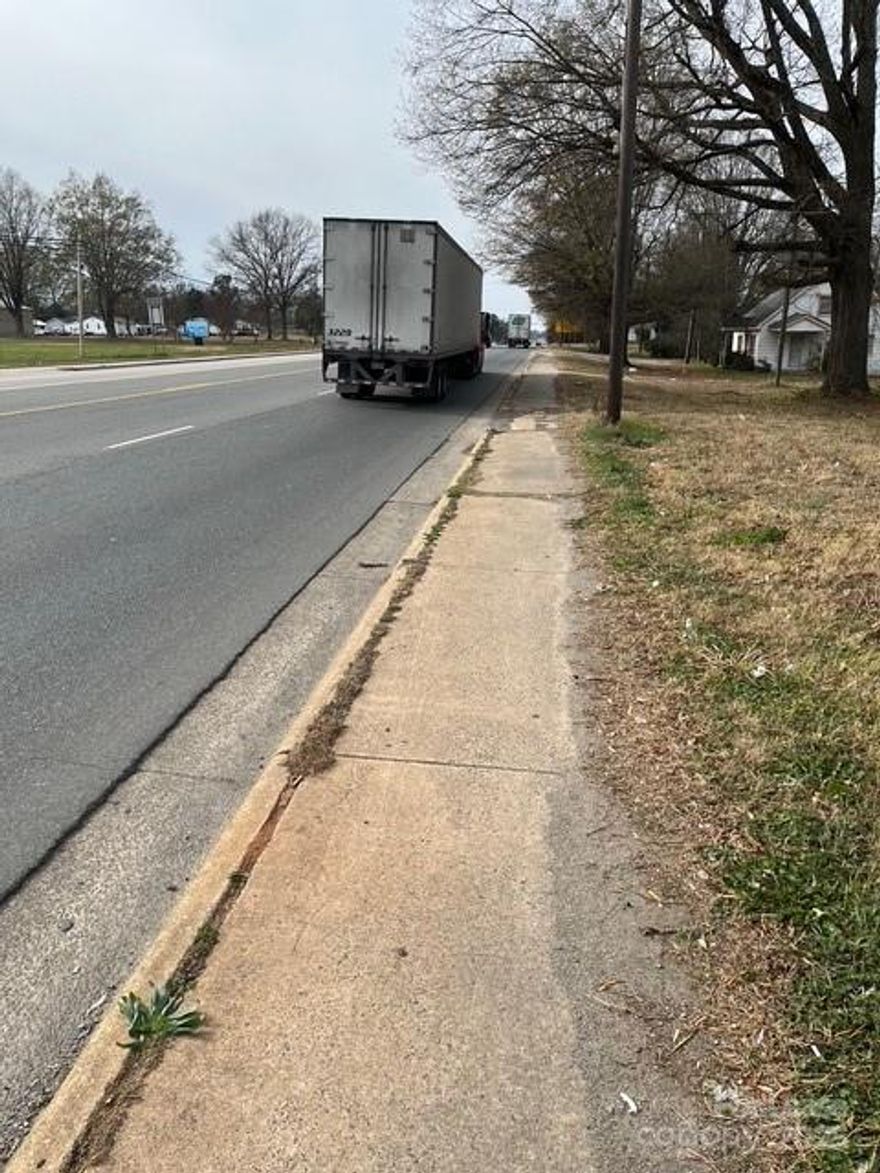 This property must be sold with 6137 W Marshville Blvd.  The total property will rent for $6000 per month on a long term ground lease  There are 2 curb cuts on Hwy 74 and a little bit over 1 acre of dirt.  The property is located between a Speedway and Qt.  It is less than a mile from the Exit for the Monroe Bypass on Hwy 74.