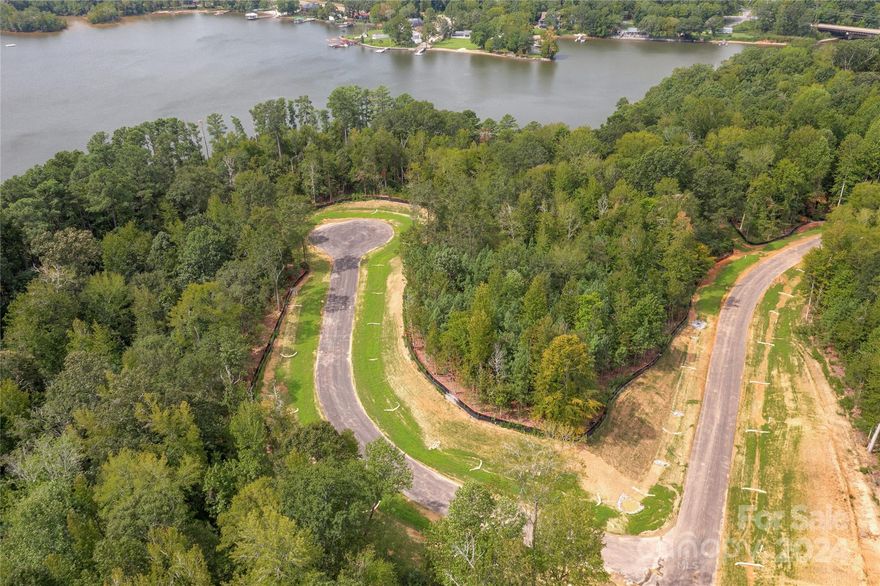 Waterfront and dockable homesite in McLean South Shore in Belmont NC on Lake Wylie. Homesite 9 at 1008 Kingbird Lane, Clover South Carolina is located on western edge of the main channel with view south. The homesite catches west and east views as well! An incredible homesite indeed! McLean South Shore offers walking trails, clubhouse, outdoor pool, fitness center, playground. Drift restaurant within walking or golf cart distance. The Carolina Thread trail along Lake Wylie located across New Hope Road. Within minutes of grocery shopping - Publix and Harris Teeter. Plus minutes from the walkable City of Belmont with its quaint vibe, festivals, park, playground, active train line - kids love watching the train, restaurants and shopping. The bustling Charlotte Douglas airport is about 15 minutes away for easy travel access. Uptown Charlotte, South Park and Ballantyne are commutable via nearby highways. Great small town location at doorstep of a bigger city! Premier waterfront community!