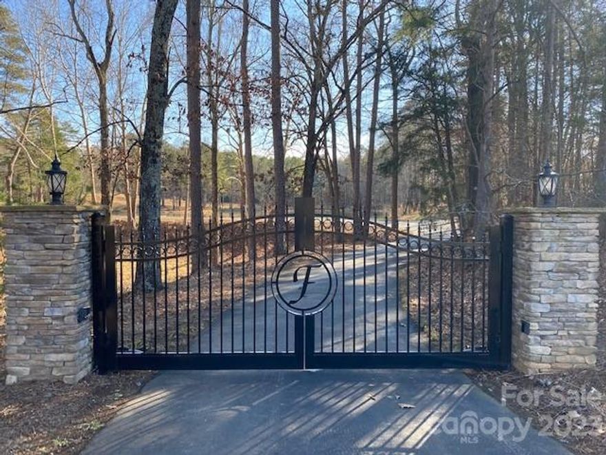 Enter the paved driveway past the stone columns and through the electronic gates, turn left and you come upon the magnificent homesite and circle drive up on the hill overlooking the lovely pond in front, with the backdrop view of mature hardwoods and pines. Tranquility, peace, and privacy abound on this nearly 47-acre property. Pursue building your dream home with country living, gardening and recreational activities. Build a cabin, bring your RV and utility vehicles, make this your summer and weekend retreat. There is a very nice 36' x 60' shop building on the property with an office, equipped with a mini split HVAC system. Located only five minutes to a boat landing access on Lake Tillery, the Town of Norwood and not far away from Albemarle, Charlotte and Concord. This is a unique opportunity to own property of this size with privacy, and close to town, grocery stores and a US highway. No driving isolated backwoods and country roads to get there, Hurry, this is the one !