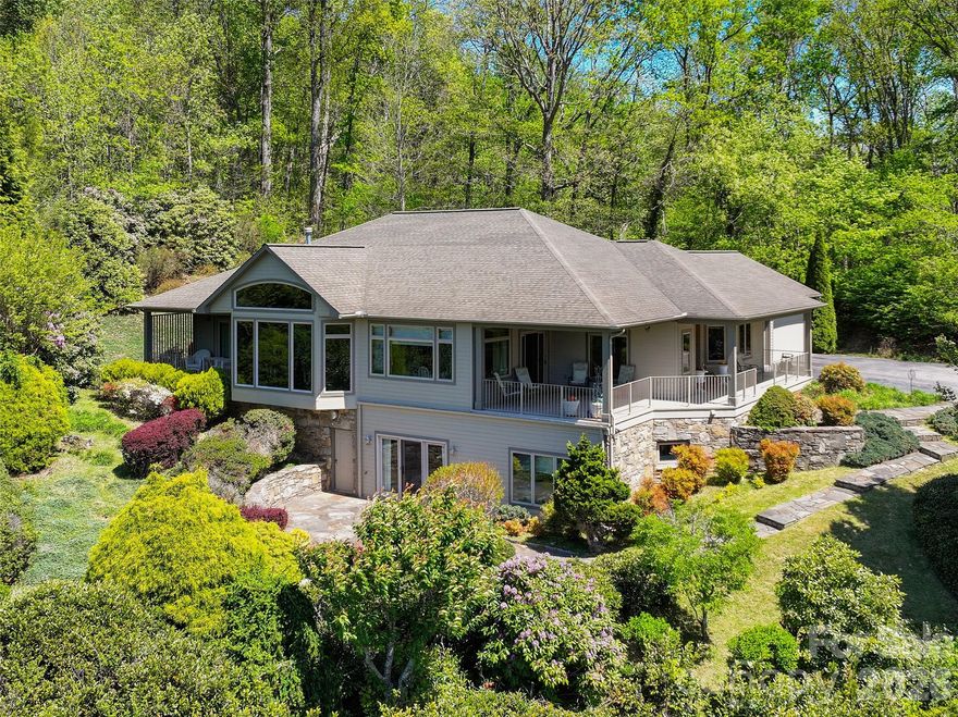 An extraordinary opportunity to own a premier mountain retreat overlooking Hole #15 at Laurel Ridge Country Club. Perfectly positioned to capture breathtaking long-range vistas, extensive landscaping and unforgettable sunset views, this home blends timeless craftsmanship with a setting that feels truly special.

Designed for effortless main-level living, the home features a primary suite on the main floor, along with a comfortable guest bedroom, making it ideal for both everyday living and hosting visitors. An expansive main-level office showcases elegant transom windows that flood the space with natural light, creating an inspiring environment for work or creative pursuits.

The heart of the home includes a welcoming breakfast area with panoramic views, where mornings begin with sweeping sights across the fairway and evenings end with the sky painted in sunset hues. Thoughtful indoor-outdoor flow keeps the stunning golf course and mountain backdrop front and center throughout the main living spaces and the three covered porches.

Practicality meets convenience with a two-car attached garage, plus a third garage bay perfectly suited for your golf cart. Generous driveway space and additional parking provide ample room for guests, making entertaining easy and enjoyable.

The lower level enhances the home’s versatility, featuring a private guest suite and a spacious multi-use recreation area complete with a small kitchen—ideal for extended stays, entertaining, or flexible living arrangements. This level also offers walk-out patio access, seamlessly connecting indoor living to the peaceful outdoor setting. In addition, the lower level provides nearly 2,000 square feet of storage space, offering exceptional room for seasonal items, hobbies, or future customization.

From the serene mornings overlooking the course to golden-hour sunsets across the ridgeline, this home delivers a lifestyle defined by comfort, elegance, and exceptional views—a rare offering in Laurel Ridge where golf, mountain living, and refined design come together in perfect harmony.