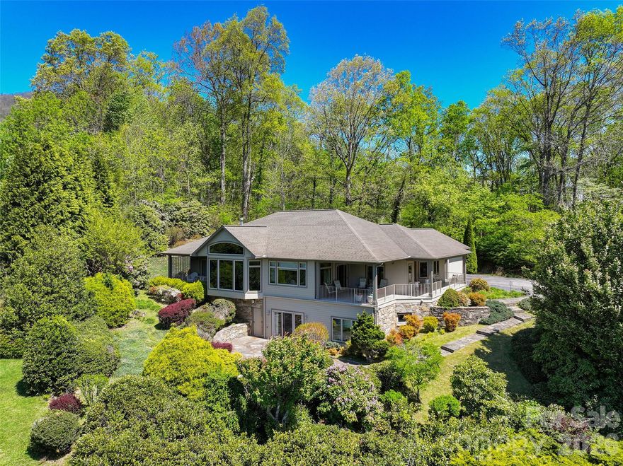 An extraordinary opportunity to own a premier mountain retreat overlooking Hole #15 at Laurel Ridge Country Club. Perfectly positioned to capture breathtaking long-range vistas, extensive landscaping and unforgettable sunset views, this home blends timeless craftsmanship with a setting that feels truly special.

Designed for effortless main-level living, the home features a primary suite on the main floor, along with a comfortable guest bedroom, making it ideal for both everyday living and hosting visitors. An expansive main-level office showcases elegant transom windows that flood the space with natural light, creating an inspiring environment for work or creative pursuits.

The heart of the home includes a welcoming breakfast area with panoramic views, where mornings begin with sweeping sights across the fairway and evenings end with the sky painted in sunset hues. Thoughtful indoor-outdoor flow keeps the stunning golf course and mountain backdrop front and center throughout the main living spaces and the three covered porches.

Practicality meets convenience with a two-car attached garage, plus a third garage bay perfectly suited for your golf cart. Generous driveway space and additional parking provide ample room for guests, making entertaining easy and enjoyable.

The lower level enhances the home’s versatility, featuring a private guest suite and a spacious multi-use recreation area complete with a small kitchen—ideal for extended stays, entertaining, or flexible living arrangements. This level also offers walk-out patio access, seamlessly connecting indoor living to the peaceful outdoor setting. In addition, the lower level provides nearly 2,000 square feet of storage space, offering exceptional room for seasonal items, hobbies, or future customization.

From the serene mornings overlooking the course to golden-hour sunsets across the ridgeline, this home delivers a lifestyle defined by comfort, elegance, and exceptional views—a rare offering in Laurel Ridge where golf, mountain living, and refined design come together in perfect harmony.