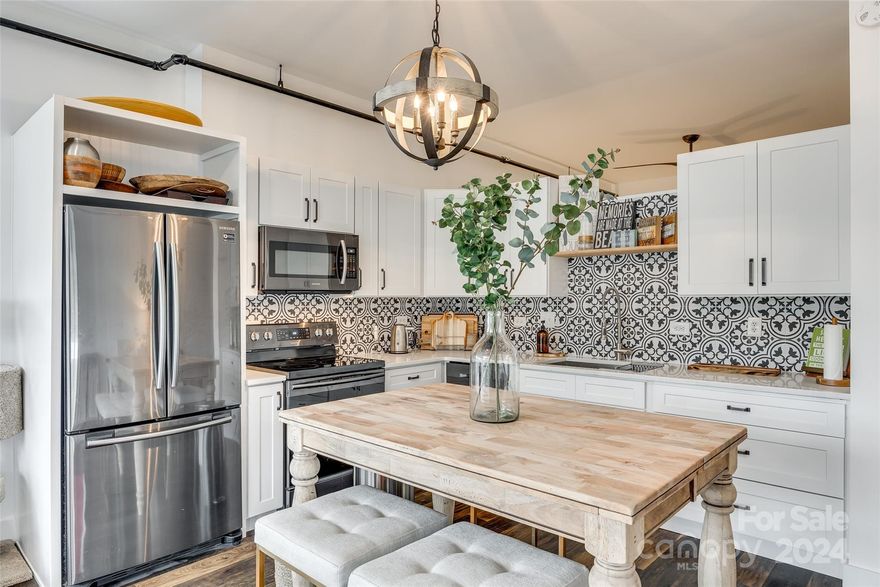 Discover this stunning corner-unit loft with an open floorplan on the top floor of Central 27, situated in the heart of Plaza Midwood. This bright and airy unit offers a unique living experience with 13 foot ceilings and a garage door that opens to a balcony off the kitchen. The balcony is complete with a retractable screen for a seamless indoor/outdoor feel and ideal for entertaining or relaxing. The beautifully designed and updated kitchen features quartz countertops and stainless steel appliances. The unit also includes a custom barn door, custom closet systems, and a tankless water heater. HVAC updated in 2022 and the seller has a service plan for routine touch-ups. Just blocks from the best of Plaza Midwood - groceries, restaurants and nightlife are all within a mile! Don't miss out on this rare opportunity to experience the best of city living in one of Charlotte's most sought after neighborhoods!