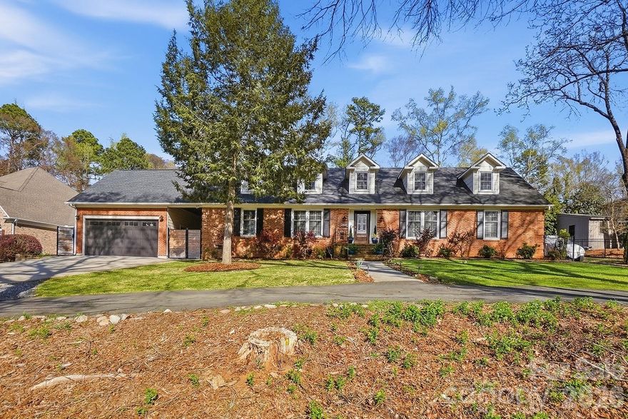 Timeless full-brick residence offering 5 bedrooms and 3 baths in one of South Charlotte’s most sought-after established communities. Blending classic charm with modern livability, this home features rich hardwood floors and an expansive, open-concept kitchen and living area designed for effortless entertaining. The owner’s suite provides a private retreat with en suite bath, while the upper level offers a versatile bonus space, cozy reading nooks, and generous walk-in attic storage. Outdoor living is elevated with a spacious deck and hot tub overlooking a fully fenced, private backyard. A detached, temperature-controlled flex space—ideal for a gym or studio—adds exceptional versatility, complemented by an oversized garage with abundant storage. Enjoy a rare combination of privacy and neighborhood with trails and lake, just minutes from top-rated schools, premier dining, shopping, and easy access to 485 and Providence Road.