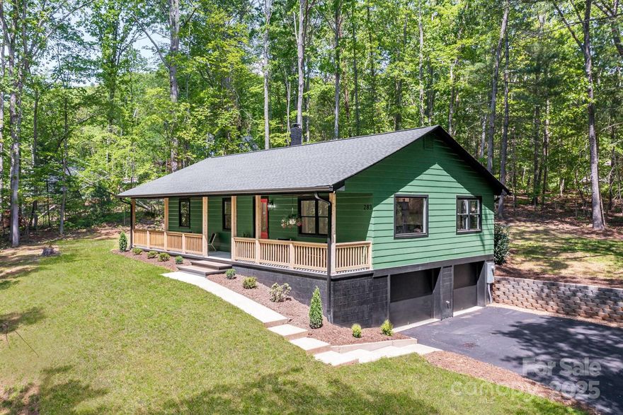 Relax and unwind on the covered front porch—complete w ceiling fans & serene views—perfect for enjoying quiet mornings or peaceful evenings. Tucked away on a private 0.85-acre lot, this meticulously renovated 3BR/2BA home blends mountain charm w modern ease—just minutes from downtown, South Asheville, & all the area has to offer. Inside, a bright open floor plan showcases a designer kitchen w quartz countertops, custom cabinetry & furniture-style island. A picture window in the living room frames wooded views, bringing nature indoors. The main-level primary suite features a spa-like bath, walk-in shower, dual vanity & custom closet. 2 additional bedrooms offer flexible living space. Enjoy the outdoors from the oversized back deck or the level side yard, ideal for play or pets. The extra-deep 2-car garage is perfect for a workshop, storage, or future expansion. With all-new systems & stylish upgrades throughout, this turn-key home offers quiet, refined living in a tranquil setting.