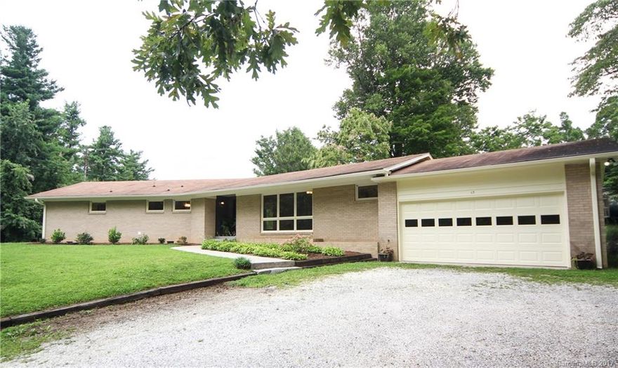 Beautifully updated one level contemporary home with new hardwood floors throughout, new spacious kitchen with granite and stainless, with island and walk in pantry.  New master suite with glass shower, double vanities & granite, large walk-in closet.  Additional features include 2BRs with updated guest bath, laundry room, 2 car garage, and incredible 1.23 acre tract.  Additional .97 acre tract available. Owner is NC Licensed Broker