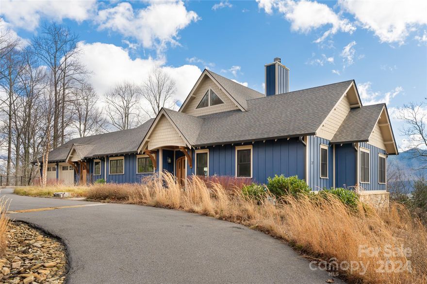 This custom-built masterpiece showcases unparalleled luxury amidst the backdrop of the Blue Ridge Mountains. Step inside the expansive living area which features a vaulted ceiling, stone fireplace, and oversized windows framing panoramic views of the surrounding mountains. The gourmet kitchen is equipped with top-of-the-line appliances, custom cabinetry, and granite countertops. The primary suite includes custom built in's and a walk-in-closet with an oversized shower and dual vanities in the primary bath. An expansive, covered back deck features a gas fireplace. On the terrace level a large family room with custom built in's leads out to a lower patio. This level also includes two guest bedrooms, a full bath, and a bonus/gym room. Enjoy a 2-car garage on the main level and an additional 3-car garage on the terrace level providing space for a workshop, storage, or future expansion. Additional features include an elevator, 2 HVAC systems, an alarm system, and double homesite.