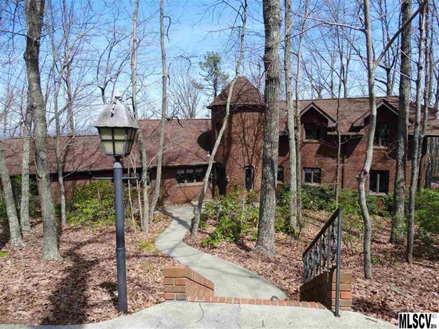 Breathtaking long-range mountain views from this unique 6.8 acre property situated on Mineral Springs Mtn. All brick, 2-story home with full basement offers plenty of parking w/double attached garage, detached garage & 11 paved parking spaces off the street. Impressive turret/tower style entry foyer w/marble floors & grand spiral staircase. Living room w/cathedral ceiling, gas log fireplace & beautiful wood parquet floors. Formal dining room w/access to rear deck. Kitchen w/updated granite & Corian countertops & separate dining area. Cozy den w/access to rear deck. Main level MBR suite w/3 closets (1-WIC) & private MBA. 2nd BR on main level & full BA. 2nd level offers 2 bedrooms, full bath & walk-in attic area. Basement offers a den w/fireplace, large entertaining/recreation area w/full kitchen & access to lower deck, office, laundry room, workshop area & 1/2 BA. New roof in 2013. All windows have been replaced. 2 heat pumps, security system & central vacuum.