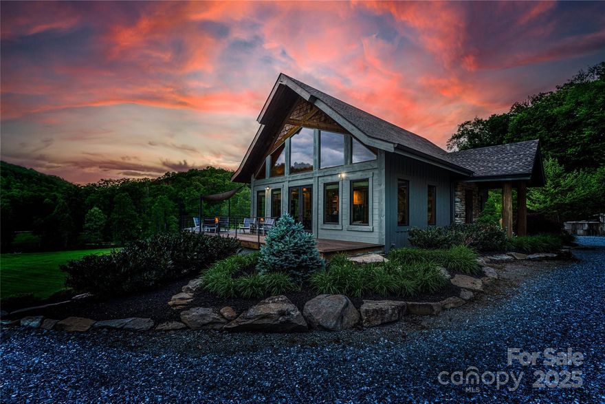 Back on the market—no fault of the sellers! They are motivated and ready to welcome new owners.
Experience the very best of mountain living in this exquisite custom-built retreat, where timeless craftsmanship, thoughtful design, and breathtaking natural surroundings come together in perfect harmony. Nestled on just over five serene acres, this stunning four-bedroom, three-bath home was designed to take full advantage of its mountain setting—offering both privacy and sweeping views from nearly every room. From the moment you arrive, the attention to detail is unmistakable. The open-concept main level creates an effortless flow between the great room, dining area, and kitchen, making it ideal for both everyday living and entertaining. Vaulted ceilings, exposed beams, and rich wood finishes bring warmth and character, while expansive windows invite in natural light and frame the picturesque landscape beyond. Step out onto the spacious deck to enjoy your morning coffee surrounded by birdsong, or gather with friends in the evening as the sun sets over the ridges. The lower-level den, with walk-out access, offers additional living space that is perfectly suited for guests, a media room, or a family recreation area. Every space in this home has been thoughtfully designed to blend comfort, function, and beauty. For the hobbyist or craftsman, a dedicated workshop provides endless possibilities—whether you’re woodworking, tinkering, or simply enjoying a quiet creative space. Just beyond, the adjoining gathering area and fire pit create the perfect setting for outdoor entertaining, storytelling, or peaceful nights beneath the stars. Located in a tranquil setting yet still within easy reach of Asheville and Hendersonville, hiking trails, and everyday conveniences, this property offers the ideal balance between retreat and accessibility. Whether you’re searching for a full-time residence, a family getaway, or a peaceful haven to reconnect with nature, this home delivers the ultimate mountain lifestyle—elegant, inviting, and uniquely yours. Come experience for yourself what makes this property so special. From its handcrafted details to its expansive outdoor spaces, it embodies the spirit of refined mountain living and the feeling of truly being “home.”