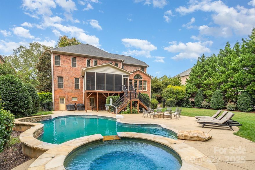 Exquisite luxury awaits in this stately full-brick residence, perfectly situated within the prestigious gated community of Providence Downs. Offering five bedrooms and five full baths across three beautifully finished levels, this home is a masterful blend of timeless architecture, thoughtful design, and comfort. Every detail has been carefully curated to provide both sophistication and functionality, making it an ideal retreat for modern living as well as effortless entertaining. The main level immediately welcomes you with a sense of grandeur. A private office provides the perfect workspace for today’s lifestyle, while the formal living spaces flow seamlessly into the heart of the home. The two-story great room impresses with soaring ceilings, walls of windows, and a dramatic gas-log fireplace—uniquely see-through to the serene screened porch. This design invites a flood of natural light and creates a seamless connection between indoor comfort and outdoor relaxation. The screened porch, overlooking the private grounds, offers an intimate setting for morning coffee or evening unwinding. The chef’s kitchen is the centerpiece of the home, boasting abundant custom cabinetry, a walk-in pantry, stainless appliances, and a large island ideal for gathering and breakfast bar. A bright dining area just off the kitchen ensures meals are enjoyed with both style and ease. Functionality is elevated with a spacious laundry room complete with sink, abundant cabinetry, and a convenient drop zone located off the garage—providing both organization and daily practicality. Upstairs, the primary suite is nothing short of a retreat. Tray ceilings crown the spacious bedroom, while a private sitting area offers a peaceful escape. The luxurious spa-inspired bath includes dual vanities, an oversized shower, soaking tub, and two generous walk-in closets that provide both elegance and convenience. Three additional bedrooms, each generously sized, are complemented by two additional full baths, ensuring family and guests enjoy privacy and comfort. The lower level is designed as an entertainer’s paradise and a true extension of the home. A sprawling recreation area is ideal for billiards, ping pong, or air hockey, making it a hub for laughter and lively gatherings. The adjoining family room features a full wet bar, creating a sophisticated space for hosting. For evenings at home, the media room promises cinematic experiences with family and friends, while the exercise room provides space to focus on health and wellness without ever leaving the comfort of home. Two large walk-in storage areas offer practicality to match the beauty. Step outside to discover an outdoor oasis. The expansive, level backyard is anchored by a sparkling heated salt water pool with a soothing overflow spa, inviting hours of relaxation and fun. A built-in stone firepit offers the perfect gathering place for cool Carolina evenings, where conversations linger and memories are made. Whether hosting summer pool parties, casual barbecues, or elegant al fresco dinners, this outdoor retreat is as versatile as it is breathtaking. Set within Providence Downs, one of the area’s most coveted gated communities, this home also benefits from a wealth of neighborhood amenities. Residents enjoy access to a private clubhouse, swimming pools, tennis courts, playgrounds, and scenic walking trails, creating a vibrant lifestyle that is both active and connected. The community’s reputation for exclusivity, natural beauty, and security makes it one of the most desirable places to call home. This exquisite property is more than a house—it is a lifestyle statement. From the refined interior spaces to the unparalleled entertainment options and outdoor sanctuary, every element has been designed to elevate daily living. For the discerning buyer seeking elegance, comfort, and the prestige of gated luxury, this Providence Downs residence presents a rare opportunity to experience the very best of Carolina living