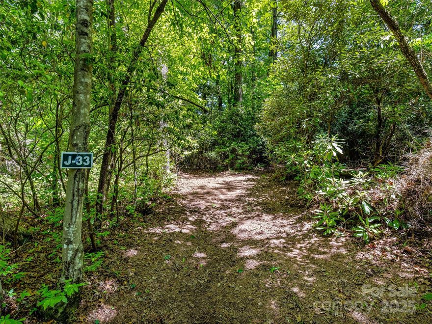 Prime golf course lot in prestigious Lake Toxaway Estates! Situated on the 12th hole with gentle topography, this easy-to-build lot offers privacy, native hardwoods, and serene views. Enjoy the peace of a quiet cul-de-sac while being just minutes from the Lake Toxaway Country Club. An active 4-bedroom septic permit is already on file, making this the perfect site for your mountain retreat. Membership to LTCC is based on application and availability.