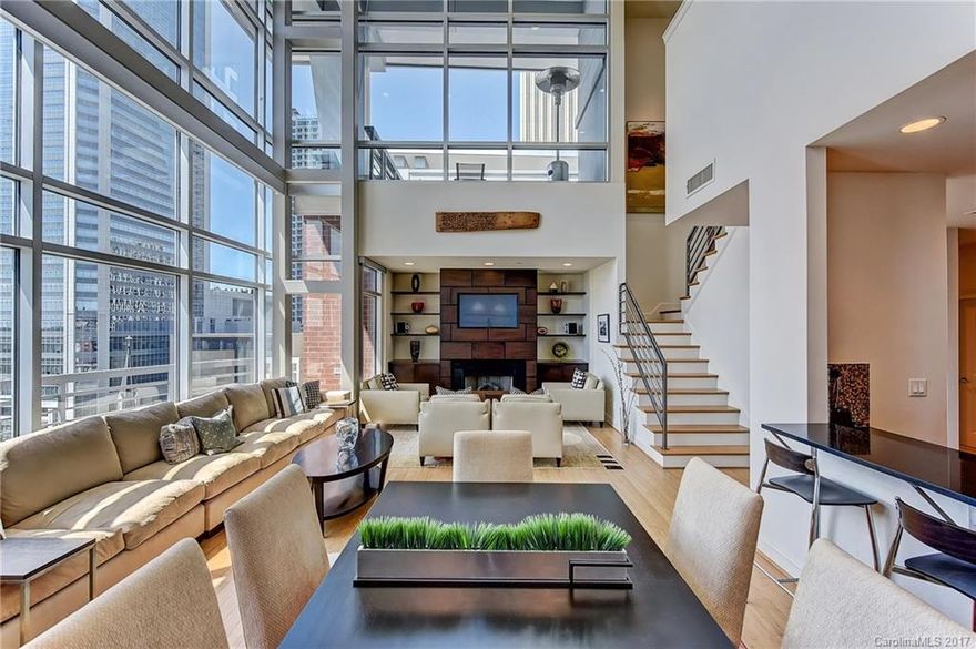 Rarely does a property offer the ultimate location and gracious indoor/outdoor living spaces. Soaring two story wall of windows bring the energy of the city into the condo. Gourmet kitchen, gas cooking, wall oven/microwave, granite c-tops, wine fridge, walk in pantry. Romantic owners suite features spa bath, dual vanities, sizable walk-in and separate office. Grab your favorite drink and spill out to the expansive roof terrace offering a variety of views. Instant access to the best of Charlotte.
