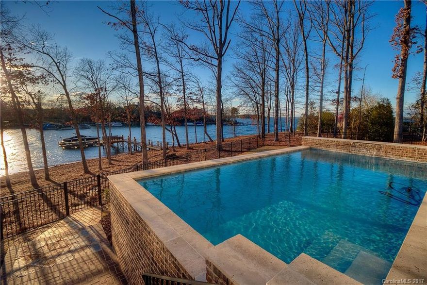 Like nothing on the market, this Charleston-style waterfront home has the highest level of finishes. Stunning water views, private dock, heated salt-water pool, exquisite master suite, magnificent kitchen w scullery. Gorgeous 5" walnut floors, custom cabinets & trim, calacatta marble, wood plank ceilings, Thermador app, Rohl fixtures, spray foam ins, sealed crawl. Separate entry guest house over garage. Ext list of features for most sophisticated buyers looking for new. Must see video!