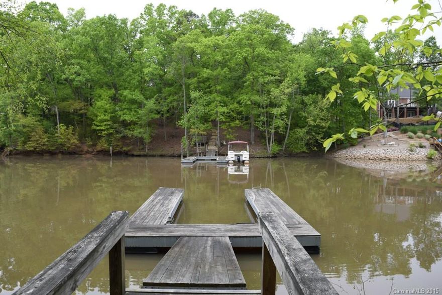 Waterfront lot in community with fine custom homes!  Just a short walk from the community pool, and located in the excellent Clover school district.  Wooded lot offers plenty of privacy, and is on a cove opening to the Big Allison inlet of Lake Wylie.  Perfect area for boating and watersports!  Dock is in place, ready for you to enjoy while building your home.  Convenient to Charlotte, Gastonia, and Rock Hill.