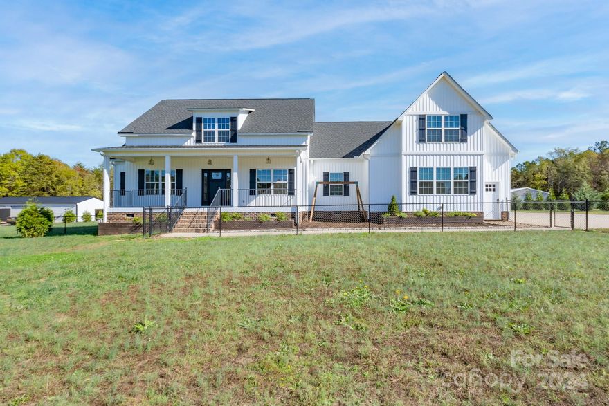 This modern farmhouse is such a unique property that is sure to impress!  The main floor features a family room with fireplace that opens to the kitchen, breakfast area, and dining room.  A spacious primary suite includes a shower, soaking tub, and double vanities.  Three additional bedrooms and a second bath complete the main floor.  Upstairs is home to an expansive bonus room and full bath.  The covered back porch provides an amazing entertainment space that overlooks a private oasis including a sparkling pool with cascading water.  A detached second living quarters features a beautiful kitchen, bedroom, two baths, and sitting room as well as a custom-designed closet, plantation shutters, and screened porch.  This space can provide awesome possibilities for the new owners.  An oversized double garage is attached to the home and there is an additional detached garage with over 1400 square feet of workshop space.  Come see all this property - that includes over five acres - offers you!