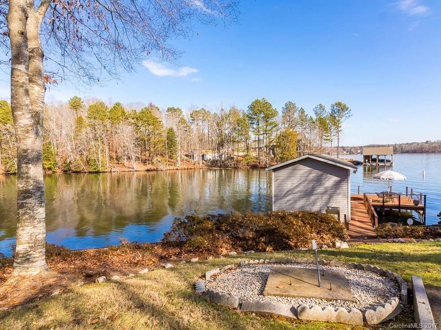 DEEP WATER 12 foot plus off end of the dock, located right off main channel.  Updated one owner ranch home with HW floors, granite kitchen, masonry fireplace, beautiful view, great Charlotte side location, large master with extensive view of lake, covered porch entire length of home, covered patio, boat house, dock, boat lift, power, water, well runs irrigation only, city water, workshop under 24x24 garage, finished walk out basement, too many options to list! Worth a trip.