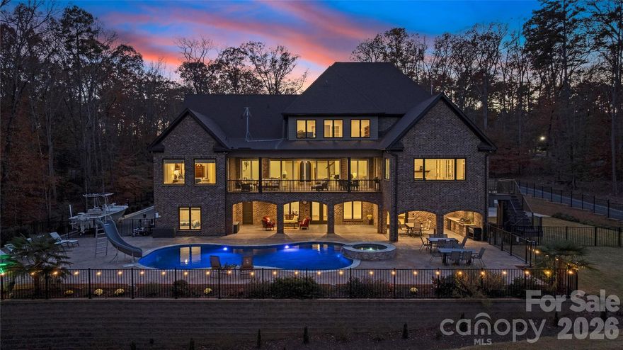 Recently appraised at $3,000,00 and now offered at $2,999,999! 
Exceptional Value on High Rock Lake! Set on nearly 3 private acres along the shores of High Rock Lake, 875 Starboard Reach delivers a rare blend of luxury, flexibility, and resort-style lakefront living. Designed for both everyday comfort and unforgettable entertaining, this custom-built estate offers panoramic water views, expansive living spaces, and seamless indoor-outdoor flow.

A showstopping nano-style folding door system opens to a fully screened veranda—creating over 30 feet of unobstructed connection between the main living area and outdoor retreat. Enjoy a heated saltwater pool and spa, outdoor kitchen, screened grilling deck, and multiple terraces designed for year-round enjoyment.

Ideal for multigenerational living or hosting, the property includes a private second living quarters above the garage with a bedroom, full bath, kitchen, laundry, and living area. The full walk-out basement adds even more versatility with an additional kitchen, media and recreation spaces, exercise room, workshop, and guest accommodations.

Outdoors, lake living takes center stage with a two-slip aluminum dock featuring a boat lift, oversized deck, and power and water access. A gated drive, mature tree-lined privacy, irrigation system, and architectural lighting enhance both convenience and curb appeal.

Thoughtfully equipped with a 10kW solar array, whole-house generator, monitored security system, and whole-property Ubiquiti WiFi, this home offers modern efficiency and peace of mind.

Located in Yachtsman’s Point, just one hour from Uptown Charlotte, residents enjoy community lake access, walking trails, and recreational amenities—while experiencing the privacy and tranquility of a true lakefront retreat.

A rare opportunity to own a turnkey, private waterfront estate—designed to live, gather, and escape beautifully.