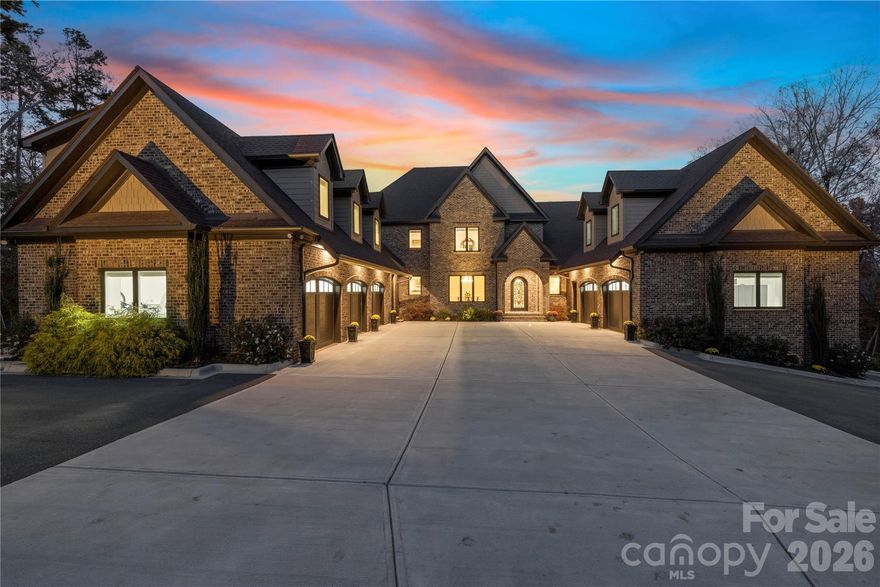 Set on the shores of High Rock Lake, 875 Starboard Reach offers an exceptional lakefront lifestyle defined by space, flexibility, and resort-style amenities. Situated on nearly 3 acres, this custom-built residence blends elevated design with everyday livability—perfect for entertaining, multigenerational living, or extended lake stays.

The main home showcases expansive living spaces with panoramic water views, multiple fireplaces, and seamless indoor-outdoor flow. A stunning nano-style folding door system opens to a fully screened veranda, creating over 30 feet of unobstructed connection between the gallery and outdoor living areas. Enjoy a heated saltwater pool and spa, outdoor kitchen, screened grilling deck, and multiple terraces designed for year-round enjoyment.

Adding rare versatility, the property includes a private second living quarters above the garage, complete with a bedroom, full bath, living area, laundry, and full kitchen—ideal for guests, extended family, or private accommodations. The full walk-out basement further expands the home’s functionality with an additional kitchen, media and recreation rooms, exercise space, workshop, and guest accommodations—perfect for hosting or creating dedicated entertainment zones.

Outdoors, lake living takes center stage with a two-slip aluminum dock featuring an oversized deck and boat lift, complete with power and water. A gated drive, irrigation system, dusk-to-dawn accent lighting, and mature tree-lined privacy complete the setting.

Thoughtfully equipped with a 10kW solar array, whole-house natural gas generator, monitored security system, and whole-property Ubiquiti WiFi, this home delivers peace of mind alongside luxury. With easy access just one hour from Uptown Charlotte, located within the Yachtsman’s Point community, residents enjoy lake access, walking trails, and recreational amenities—all while feeling worlds away.

This is more than a home—it’s a private lakefront retreat designed to live, gather, and escape beautifully.