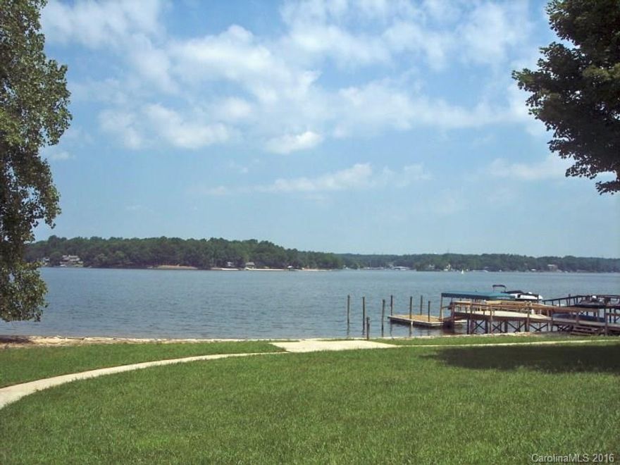 Come home to Lake living every night! Updated 3 bedroom 2.5 bath ranch on flat .86 waterfront lot. 175' waterfront w/sandy beach & boat dock. Scr porch, decking. Great views!! Eat-in kitchen; newer appliances, cabinets & wood flrs. 1st fl. Master new dbl. vanity & tile. Din area & Great rm w/frplc. overlook wonderful lake views. 2 bedrms full bath up. Scr. porch. Great wrap around decking. 2 car g.