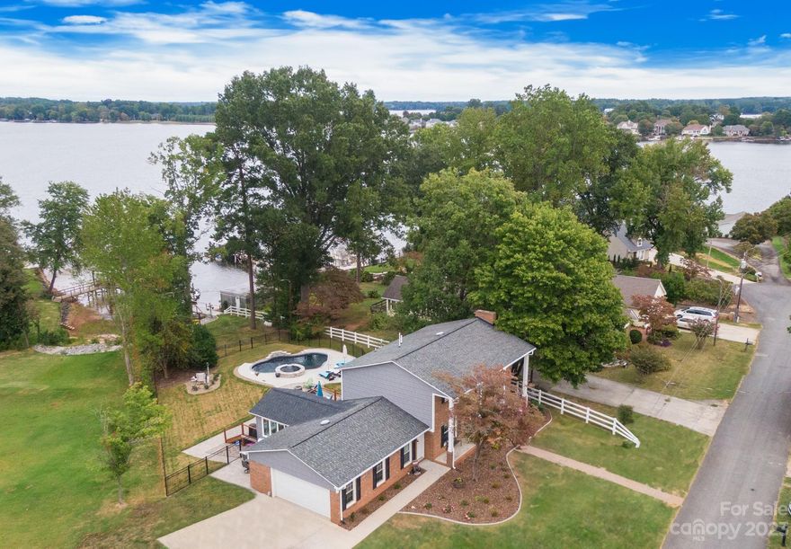 PRICE IMPROVEMENT! VERY MOTIVATED SELLER! LIVE THE DREAM on Lake Norman in this impeccable WATERFRONT home w/PRIVATE DOCK and CUSTOM POOL located in the highly sought after Westport community. You'll love the bright & open floor plan designed to entertain indoors & out. This one-of-a-kind home has been completely remodeled in every living space and is loaded w/character and thoughtfully planned custom finishes. From the hardwood floors, chef's kitchen w/upgraded marble countertops and farmhouse sink to the tranquil primary bedroom with luxurious spa-like ensuite, you are going to fall in love with this home's distinct style and charm. Enjoy your expansive composite deck overlooking the resort style pool with dual waterfalls, travertine tile and raised hot tub overlooking the glistening waters of Lake Norman. Choose to enjoy lake fun from your newly built composite dock w/ jet-ski lift and JET SKI INCLUDED! Weather proofed, UNFINISHED BASEMENT making it a perfect flex space. A true GEM!