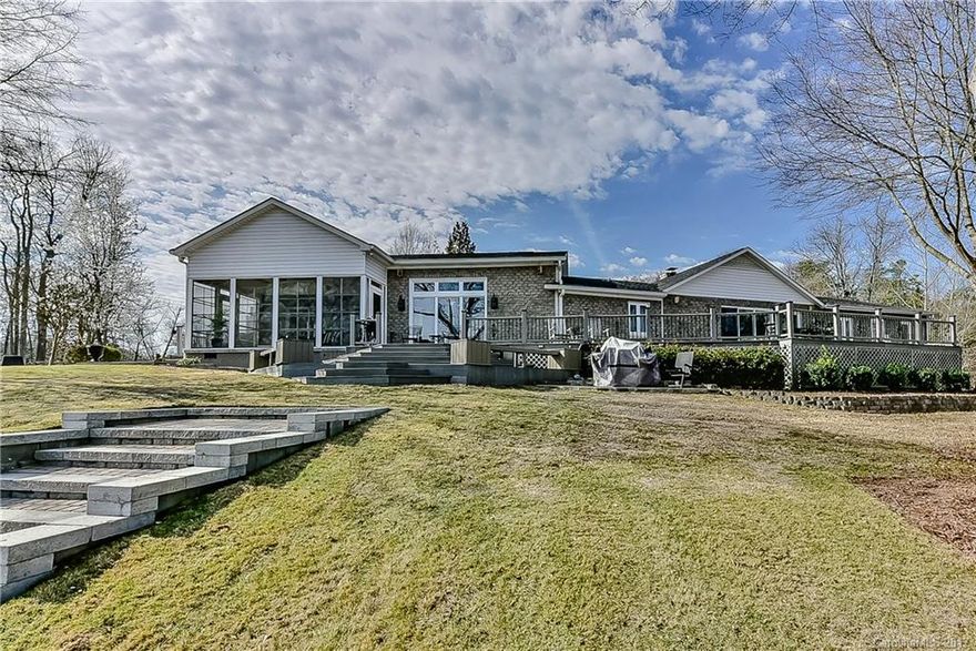 Reduced Price! Enjoy this private estate. Just under one full acre, with 135 feet of water frontage. Majority of home was completely (foundation up) remodeled in 2010, with remaining portion updated July 2016. From cabinets, counter tops, tiles/stones and floor coverings to the EZ breeze patio, large deck, yard, shade trees, retaining walls and dock. This property has it all, come see for yourself. Great laundry room and additional storage areas in attic, under deck and shelving under the home.