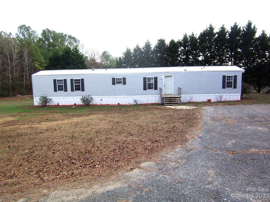 3 bedroom 2 bath home on approx 2 acres in countryside in Rutherford County. Home is built with an open floor/split bedroom plan. Kitchen & living room have vaulted ceiling. Eat-in kitchen has a center island. Laundry is large. Primary bedroom has a walk-in closet. Primary bath has a soaking tub & a walk-in shower. Vinyl flooring throughout. Great investment opportunity. Home needs some TLC. Being sold cash or conventional only.