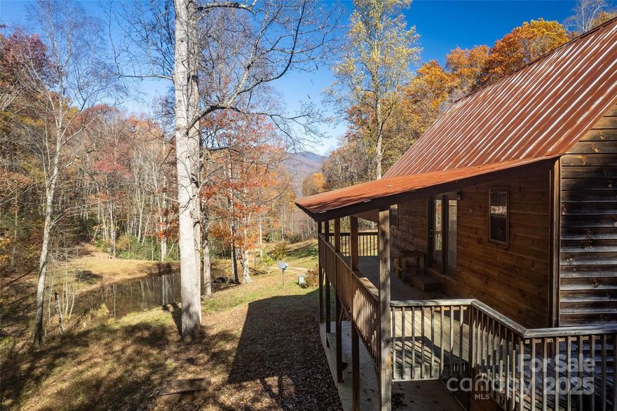 Unrestricted possibilities on this 50+ acre private estate beginning with several spacious lots with driveways and build pads. Huge mountain views and babbling branch water. Two ponds for fishing. A two bed, two bath home with hardwood floors, a large covered deck, storage space galore, and windows that bring in natural light. Bring your camper, boat and toys, there is ample space in the huge garage and workshop. Artists have a studio that is climate controlled with bathroom and storage. There is a large area for more buildings or a huge play yard, firepit, gazebo, surrounded by layered mountain views. Prime location between Sylva and Waynesville where shopping, dining, breweries, festivals, concerts, hiking, waterfalls are all nearby for your pleasure.