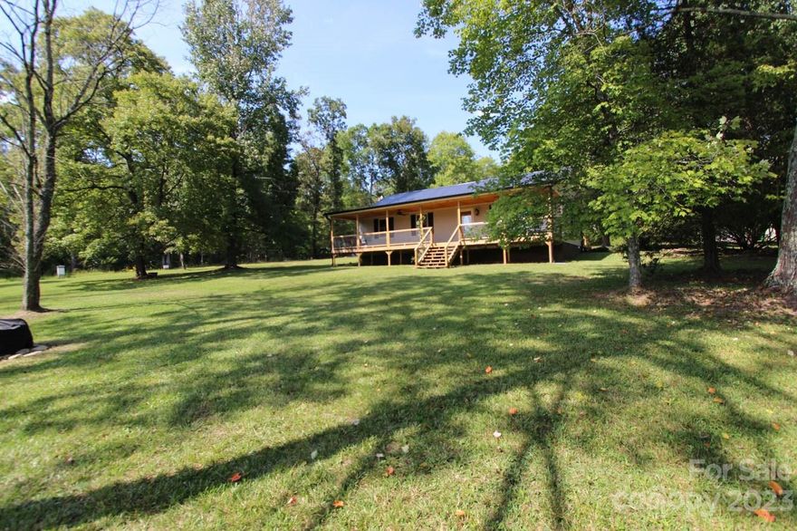 Winding driveway leads to this adorable renovated farmhouse with new full front porch and back deck.  Approximately 24 unrestricted acres with creek frontage and natural spring.Wooded with garden space, open fields or pasture. Private setting with abundant wildlife. New metal roof, new porches, new vinyl siding, new heating/air unit, new flooring, new gutters, new hot water heater, new dryer, and new commode.  House has received termite treatment with no damage noted.  Plastic has been placed on ground in crawlspace with new insulation and ducts. 
Kitchen has granite countertops and custom cabinets. Comes equipped with refrigerator, stove, microwave, dishwasher, washer and dryer. Three storage buildings and a double carport.  Separate cleared area with additional septic tank and well hookup. Map shows mobile home and two additional storage buildings but these have been removed. Come make this gem yours. This property is located north of Troy and therefore has a Star mailing route.