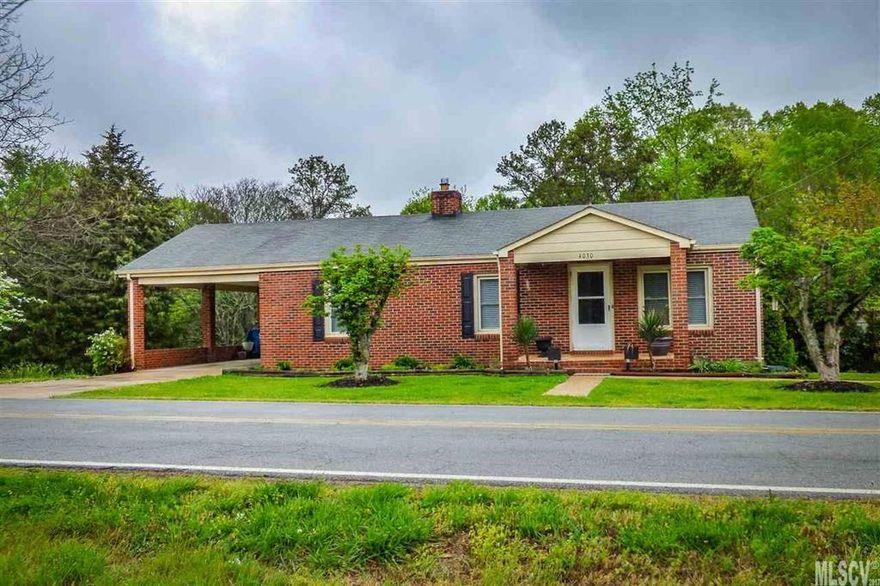 Terrific two bedroom starter home on over 1.5 acres! This all one-level home features a welcoming covered front porch, large great room with space for a dining table, kitchen with plenty of cabinetry and adjoining laundry room. Two bedrooms share a hall bath. Bonus office/den area. Low-maintenance all brick exterior with vinyl trim and replacement windows. Single attached carport, and double garage with single garage bay--tons of storage space! 1.55 acre lot, partially wooded.