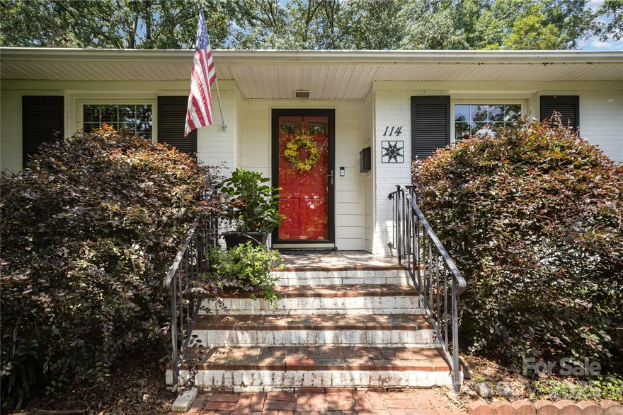 Charming brick ranch with gorgeous view of the golf course! Over half-acre lot, hardwood flooring, formals, large windows for great natural light, granite in kitchen, updated cabinets, den with built-ins and f/p, living room with f/p, large screened porch, carport and detached garage.  Stunning trees.  No HOA.