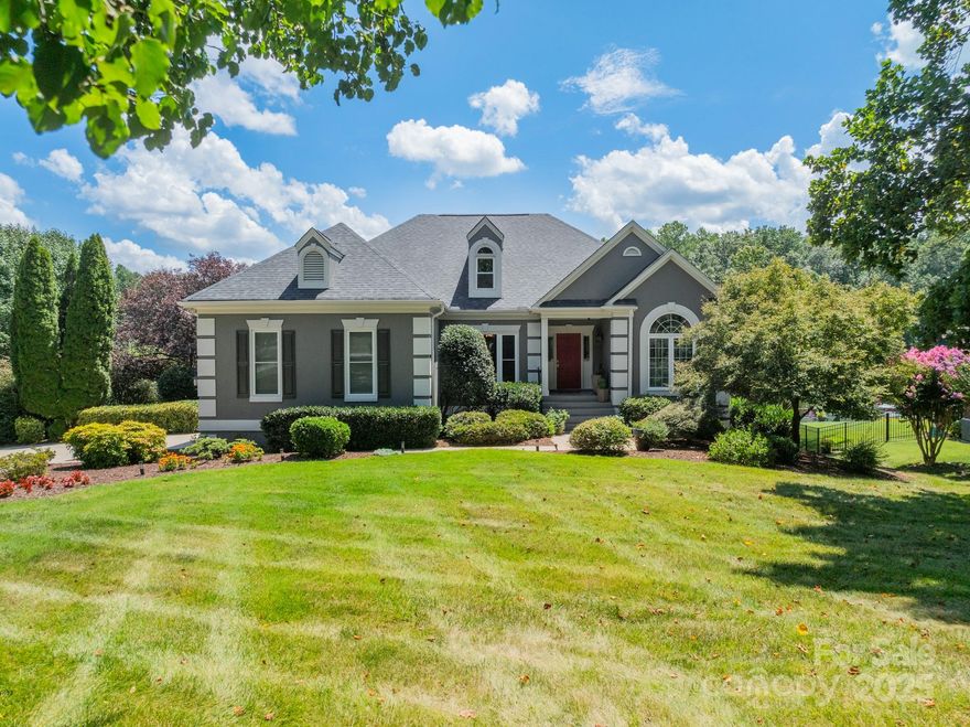 Welcome to lake living at its finest! Situated on .5 acres, this beautifully maintained property offers more than 150' of shoreline, complete with sandy beach, perfect for outdoor fun and relaxation. The flat lot provides easy access to the water and showcases stunning views of a wide, tranquil cove. Just 2 doors down, your deeded boat slip awaits. Inside, features 5 bedrooms and 3.5 baths, including two renovated ensuite bedrooms on the main level, ideal for hosting guest or multi-generational living. One additional bedroom is partially plumed for a potential ensuite addition. The updated kitchen is equipped with premium appliances, including a warming drawer and ice maker, and opens to a main-level Trex deck, perfect for entertaining or soaking in the view. Large windows and sliders flood the interior with natural light and showcase the serene lake backdrop. Enjoy the community pool, tennis and boat storage. 410 Catalina blends peaceful lakefront living with modern convenience.