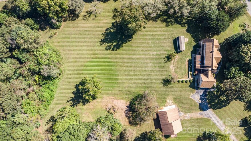 Spacious 5,000+ Sq Ft Home on 5+ Acres – No HOA! Welcome to your private retreat in beautiful Statesville! This expansive home offers over 5,000 square feet of living space and sits on more than five peaceful acres surrounded by mature trees. Step inside to discover a floor plan that combines generous space with classic comfort. The main level features a bedroom with built-in bookshelves, a formal living room, a family room with a stunning stone fireplace, a formal dining room, and a bright breakfast area overlooking the backyard. The newly updated kitchen includes brand-new cabinetry, under-cabinet lighting, and plenty of workspace. Throughout the home, you’ll find new flooring and newer carpet. Thoughtful architectural details like exposed wood beam ceilings and abundant natural light add character and charm. 
Upstairs, the spacious primary suite includes a cedar-lined closet and a comfortable en suite bathroom. One additional bedroom and a bonus room; each feature large closets, providing plenty of storage and room to unwind. There is a large screened-in porch, perfect for relaxing and enjoying the tranquil view. 
One of the highlights of this property is the lower level, offering endless possibilities. An expansive recreation room with a second stone fireplace provides a cozy setting for gatherings or movie nights, while the adjoining open area is large enough for indoor games — even a basketball hoop. This versatile space could easily function as a gym, play area, studio, or hobby workshop. 
Outside, the detached oversized garage, perfect for any car enthusiast. With space for vehicles, tools, or projects, it also features a finished bonus room above — ideal for a home office, guest suite, or creative workspace. This home offers an exceptional combination of space, privacy, and potential. With a solid structure, beautiful setting, and key updates already completed, it’s ready to move in and enjoy while allowing room for your own personal touches and modern enhancements.