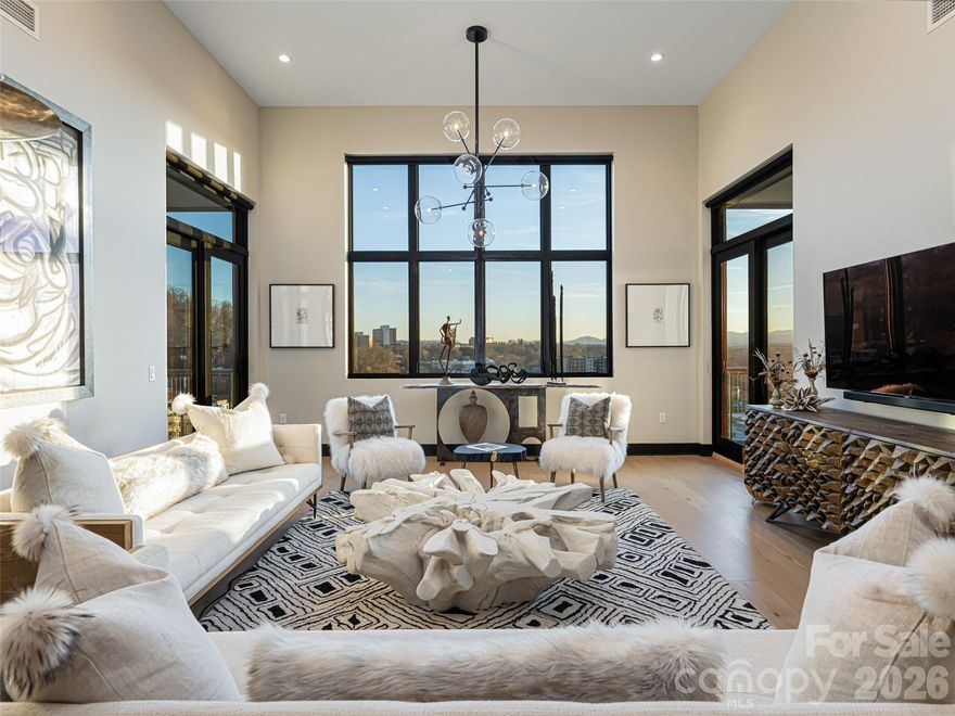 Luxury FURNISHED (ALL FURNISHINGS INCLUDED) Penthouse two bedroom, plus Bunk Room that sleeps 2, two full baths located in downtown Asheville's South Slope area offering stunning long-range Blue Ridge Mountain  views and city lights at night. Penthouse was designed and furnished by a local Asheville Interior Designer. SHORT TERM RENTALS PERMITTED. Extended Great Room combined with 15 ft. ceilings creates a spacious area to relax and entertain while overlooking the Blue Ridge Mountains. Two spacious balconies with high-end furnishings and decor. Two bedrooms with an additional "bunk room" offering additional sleeping quarters. Furnished with a contemporary flair in neutral colors, this condo is in walking distance to downtown restaurants, galleries and breweries. Secured garage parking for 2 cars with keypad entry. Two storage units.