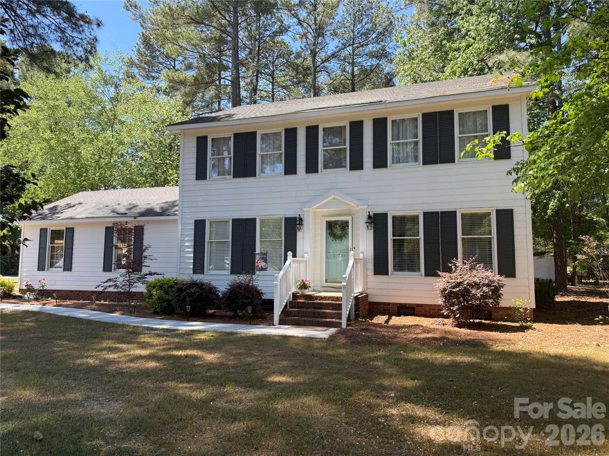 Welcome to your peaceful retreat in the desirable Woodbridge neighborhood of Laurinburg. Situated on a spacious corner lot at the end of a quiet cul-de-sac, this beautifully maintained colonial home is surrounded by mature trees, offering both privacy and charm.

Step inside to a warm and inviting main level featuring a gracious entryway, formal living and dining rooms, and a well-appointed kitchen that flows seamlessly into a generous den, perfect for entertaining or relaxing with loved ones. Updated luxury vinyl plank flooring throughout the main level adds a modern touch while enhancing durability and style.

Upstairs, you will find four generously sized bedrooms, providing ample space for rest and retreat. The expansive primary suite offers a serene escape, complete with a recently updated en-suite bathroom designed for comfort and relaxation. An updated hall bath ensures a cohesive, modern feel throughout. With dual HVAC systems, comfort is easily maintained year-round on both levels. 

This home combines classic elegance with thoughtful updates in a tranquil setting, ready for you to move in and make it your own.