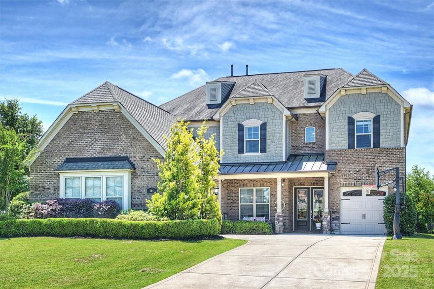 Stately brick, stone and fiber cement home in cul-de-sac with covered front porch conveniently minutes from Indian Land, Fort Mill and Ballantyne! Fabulous open floor plan with two story foyer, sweeping staircase, wide plank floors, expansive family room with coffered ceiling, spacious modern kitchen with oversized island, tile backsplash and sunroom/bar area overlooking, private, scenic yard!  Guest room and full bath on main level, secluded office nook, large laundry room, drop zone and butler's pantry leading to dining room perfect for entertaining! The upper level features a serene primary suite with sitting area, spa bath with rain shower, garden tub, and walk-in closet.  The bonus room with double doors offers great flexibility, and three additional bedrooms, two with Jack and Jill bath and walk-in attic storage complete the upper level. The oversized 3 car garage offers ample parking and storage.  Lots of opportunity for outdoor living with fenced yard, patio and community pool!