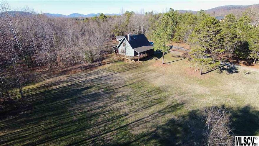 5 Acres with a custom Bear Creek Log home in the heart of Hiddenite a "true gem"! This gorgeous house has 2 OR 3 Bedrooms! The seller is currently using the potential 3rd BR as a loft area for crafts. The septic is permitted for a 3rd BR if a buyer wants to convert the loft! This gorgeous home has a massive wrap around deck overlooking the beautiful acreage! Covered back and front porches. Interior exposed beams, Large loft overlooks GR, Very good sized rooms, upper BR has built in study area. WIC's, rock foundation & chimney, SS fridge, Hanging pot rack. This home was built with rectangle logs 6inch thick by 12 inches high! The exterior logs are rough cut and interior are smooth. Both inside and out have chinking grooves. Corners are dove tailed. The roof is 10 inches thick and this home is very well insulated! 8X12 shed & outhouse garden shed! The wood stove is capable of heating the house! Quality built home! Bear Creek is a custom log home builder out of Mocksville NC!