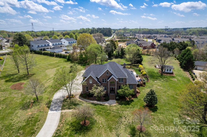Brick Estate on 2.5 Acres in Davidson! Set on a beautiful 2.5 acre lot, this full brick home offers high ceilings and elegant updates throughout creating an open, airy feel. The chef’s kitchen features high-end appliances, custom cabinetry, and a large island, perfect for both cooking and entertaining. Upstairs offers 4 spacious bedrooms, each with walk in closets and ensuite baths. Primary bedroom offers see through fireplace, sunroom and large balcony overlooking lush yard and beautiful pool. Step outside to your private oasis with a 2020 saltwater pool, a fenced garden with raised beds, and a charming potting shed. The expansive outdoor space includes a cozy wood-burning fireplace, ideal for relaxing or hosting gatherings. This home offers the perfect balance of luxury and convenience, with easy access to downtown Davidson, local schools, the Greenway system, and River Run Country Club. Enjoy the best of both worlds—privacy and tranquility, just minutes from everything you need.